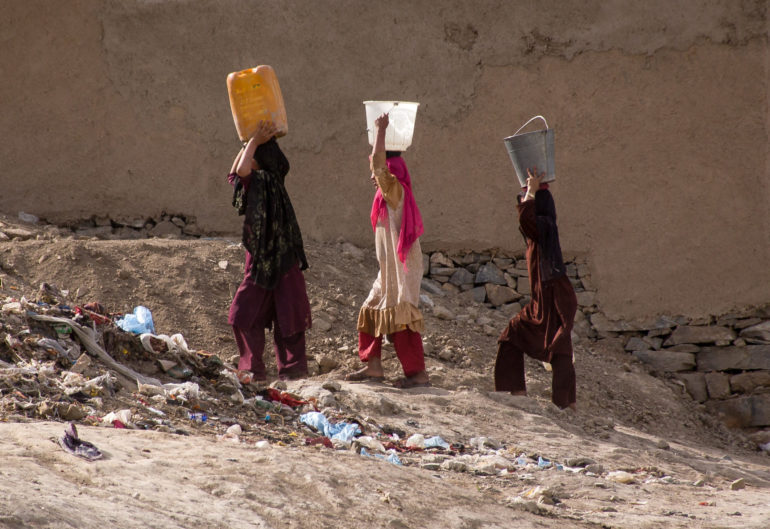 Women carrying water in Kabul, Afghanistan