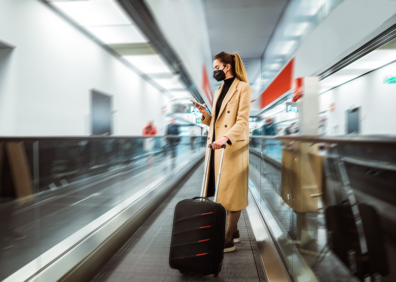 woman at airport with face mask on