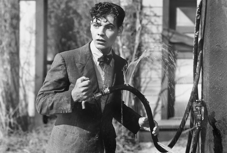 Man getting all wet from a broken hose