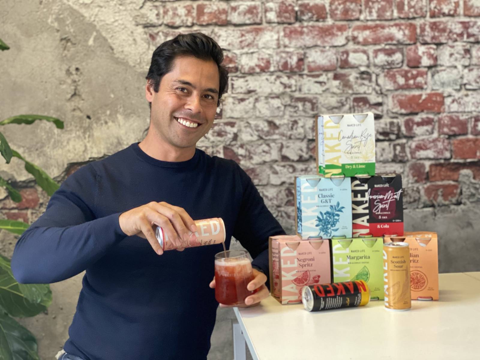 Naked Life founder David Andrews pouring a beverage