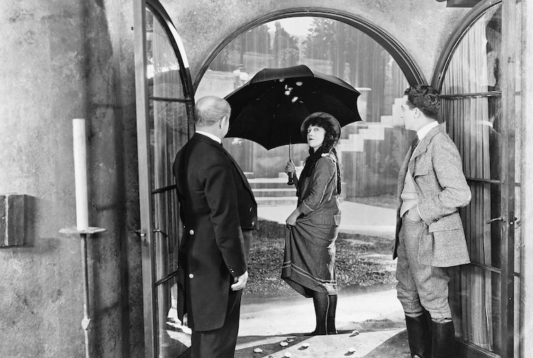 woman and two men in old black and white photo